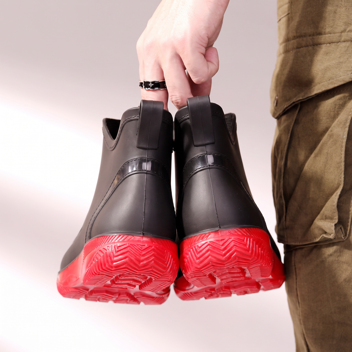 Black wellies with red soles and pull tabs, back view