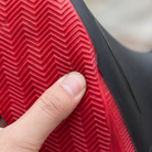 Close-up of the red sole with herringbone tread