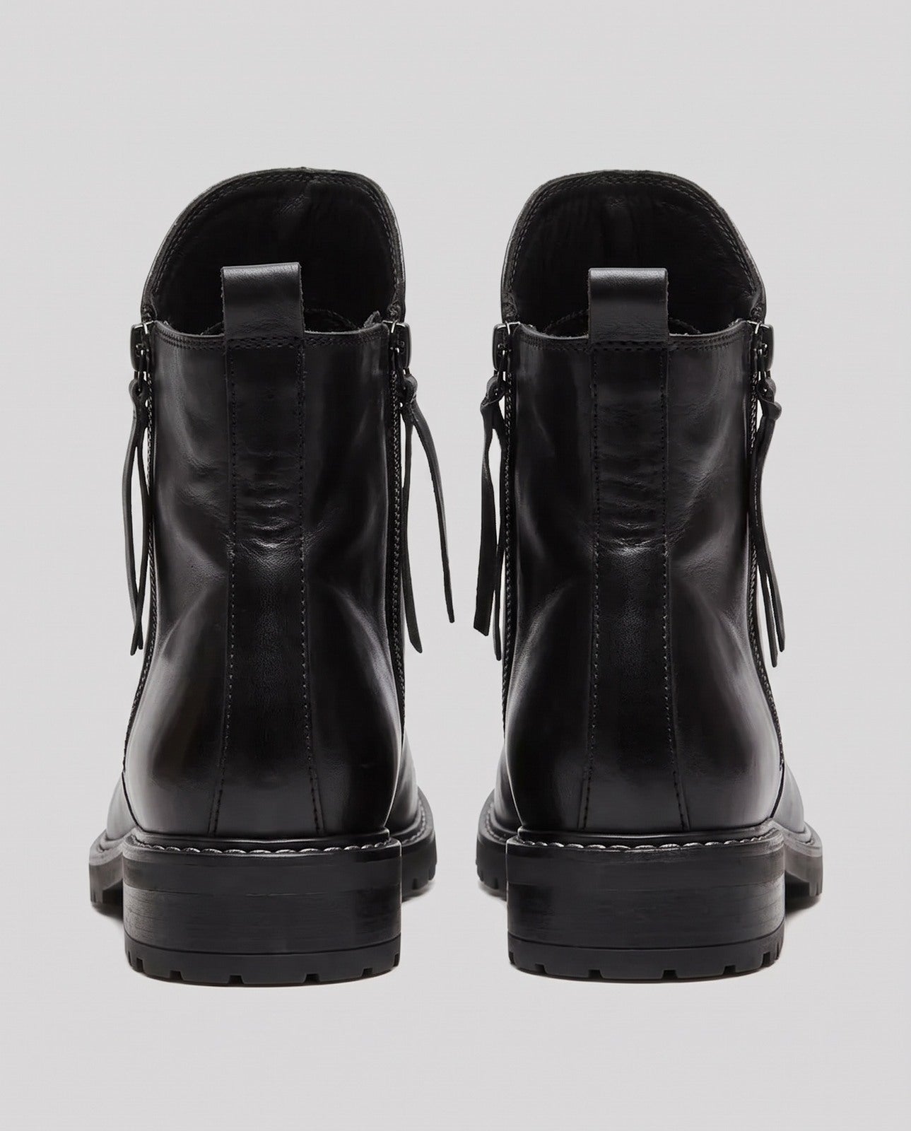Black leather ankle boots with side zippers, rear view, lug sole | Chaps London