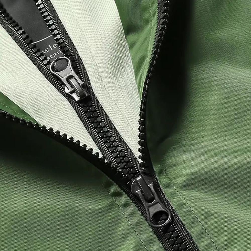 Close-up of green bomber jacket with double black zippers, fabric texture | Chaps London