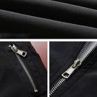 Black fabric folds and metal zipper details on jacket, flat close-up shots | Chaps London