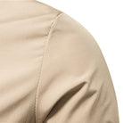 Close-up of beige fabric shoulder seam on jacket, smooth texture | Chaps London