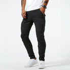 Black skinny cargo jeans with side pocket, worn by man standing | Chaps London