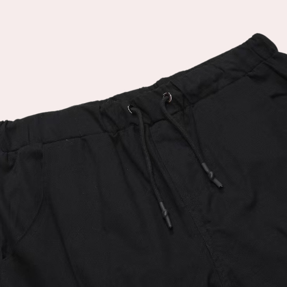 Black cargo joggers waistband with drawstring closure, close-up flat lay view | Chaps London