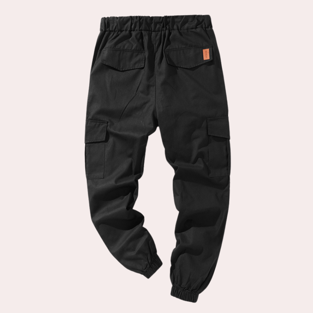 Black cargo joggers with side pockets and elastic cuffs, laid flat | Chaps London