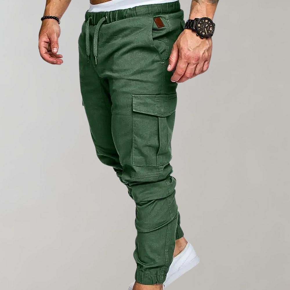 Man wearing green cargo joggers with drawstring waist and side pocket | Chaps London