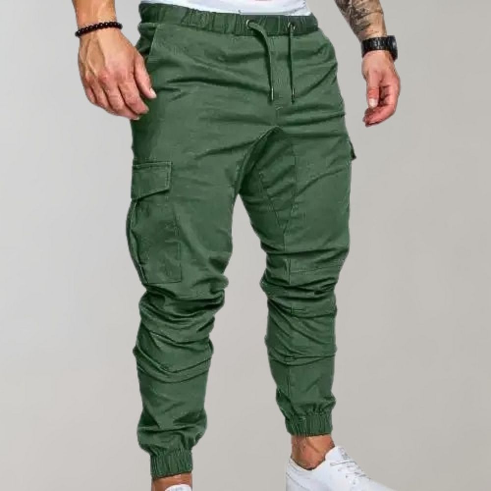 Man wearing green cargo joggers with drawstring waist and white sneakers | Chaps London
