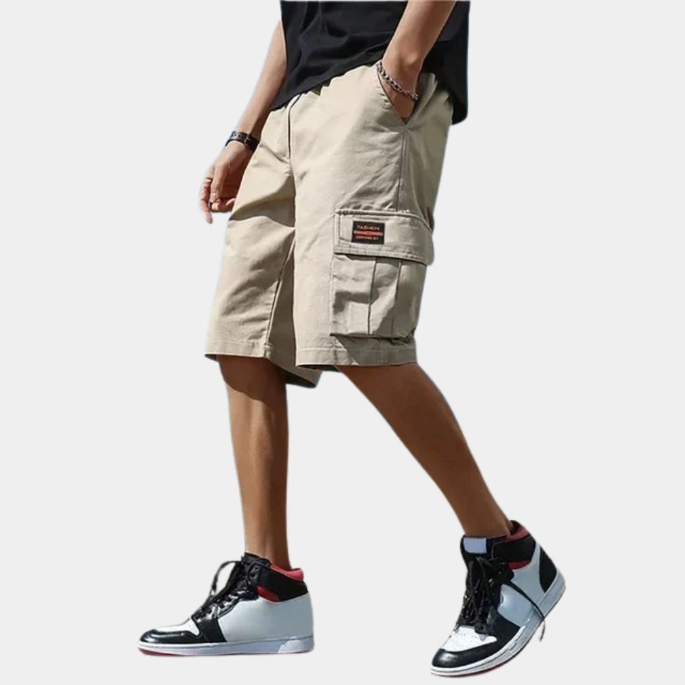 Beige cargo shorts with side pocket, worn by man, black sneakers | Chaps London