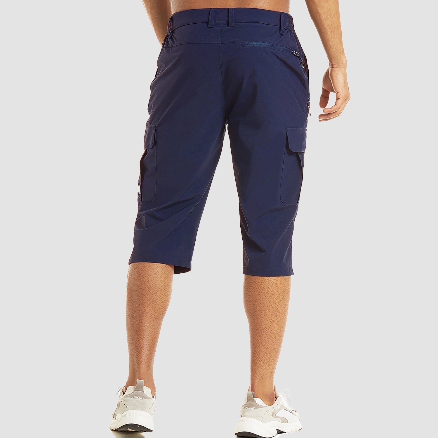 Man wearing navy blue cargo capri shorts with white sneakers, rear view | Chaps London