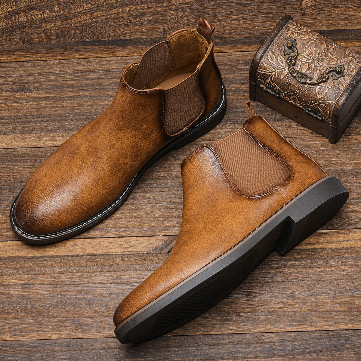 Brown leather Chelsea ankle boots pair displayed on wooden surface, flat lay | Chaps London