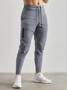 Gray stretch jogger sweatpants with zip pocket, worn by man standing | Chaps London