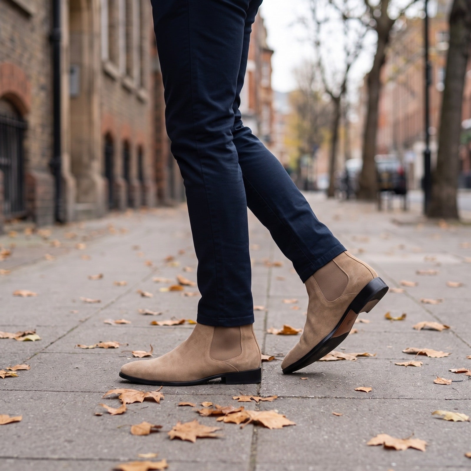Tan suede Chelsea boots worn by man walking on leaf-covered pavement | Chaps London