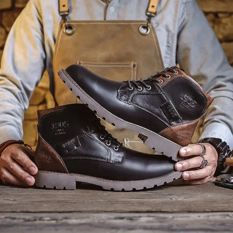 Man holding black and brown lace-up ankle boots with textured rubber soles | Chaps London