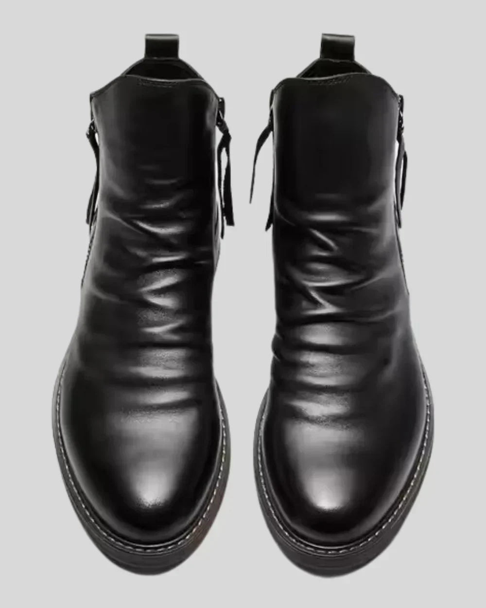 Black leather ankle boots with side zippers, shown flat-lay, front view | Chaps London