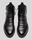 Black leather ankle boots with side zippers, shown flat-lay, front view | Chaps London