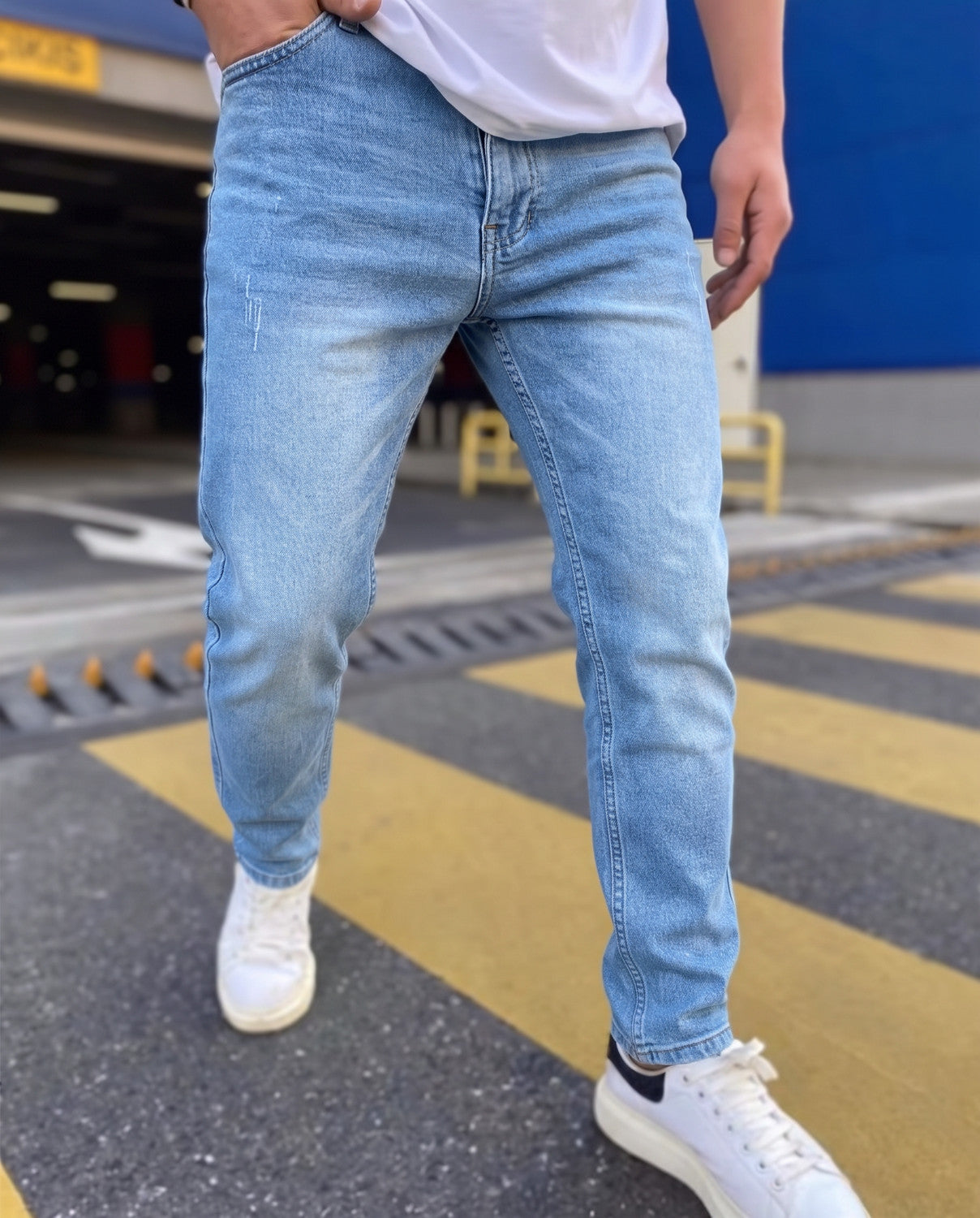Light blue men's jeans with zip fly and plain hems, worn with white trainers | Chaps London