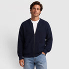 Man wearing a navy oversized chunky rib knit zip cardigan with patch pockets over a white T-shirt | Chaps London