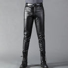 Man wearing black faux leather slim fit trousers with belt, paired boots | Chaps London