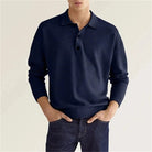 Man wearing navy blue long-sleeve collared polo sweater with denim jeans | Chaps London