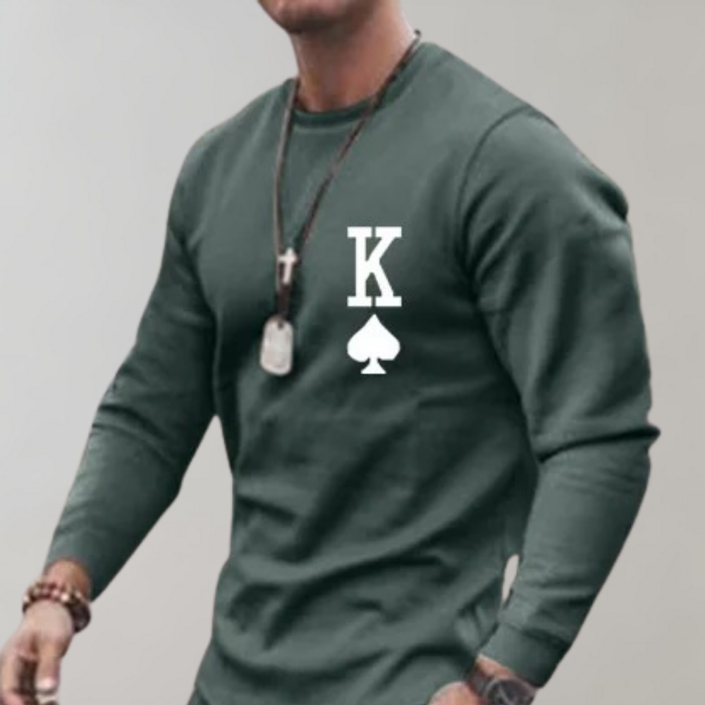 Man wearing green long-sleeve sweatshirt with playing card graphic and necklaces | Chaps London