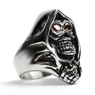 Silver ring with hooded grim reaper skull design, red eyes, shown flat | Chaps London