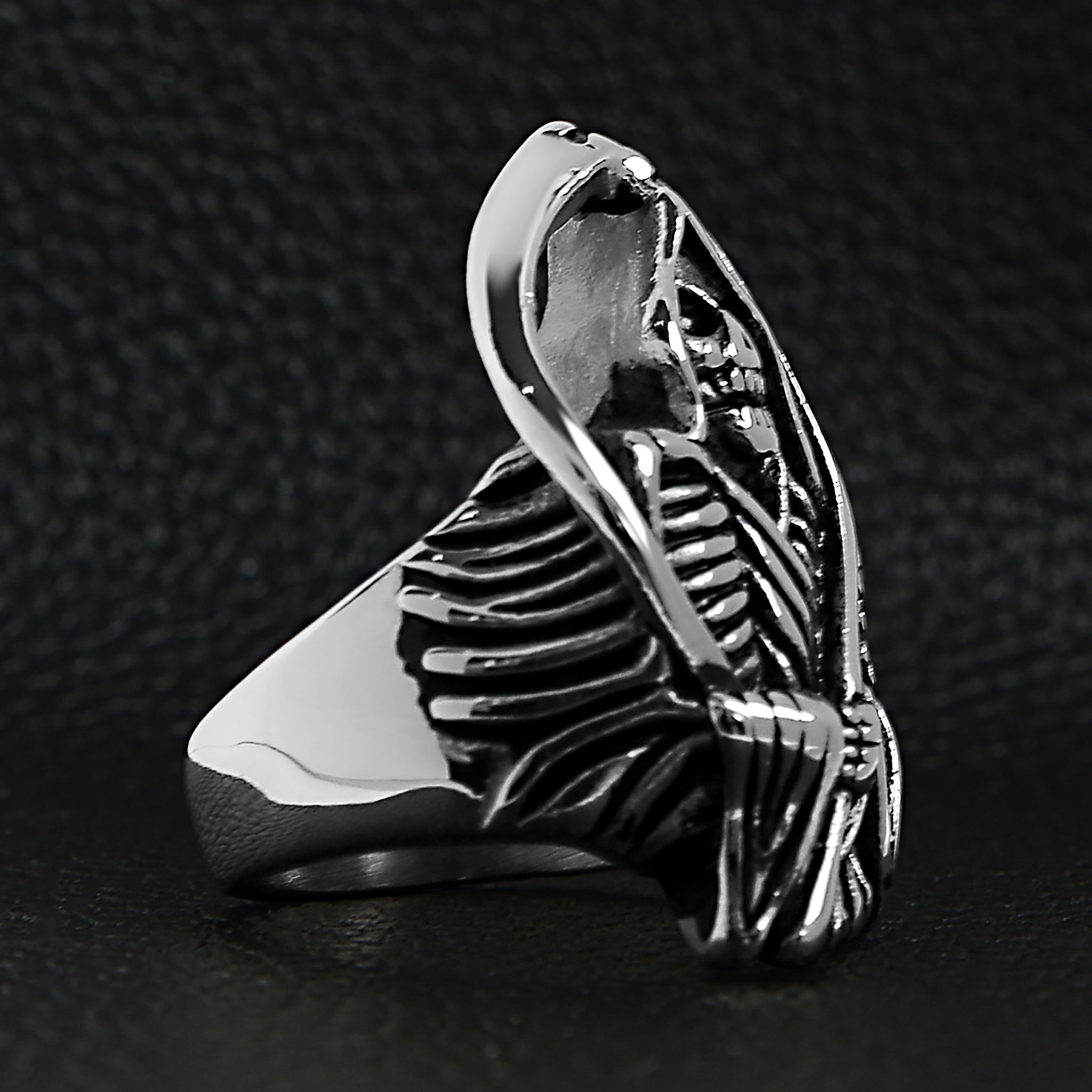 Silver grim reaper skull ring, detailed skeleton design, shown flat on black background | Chaps London