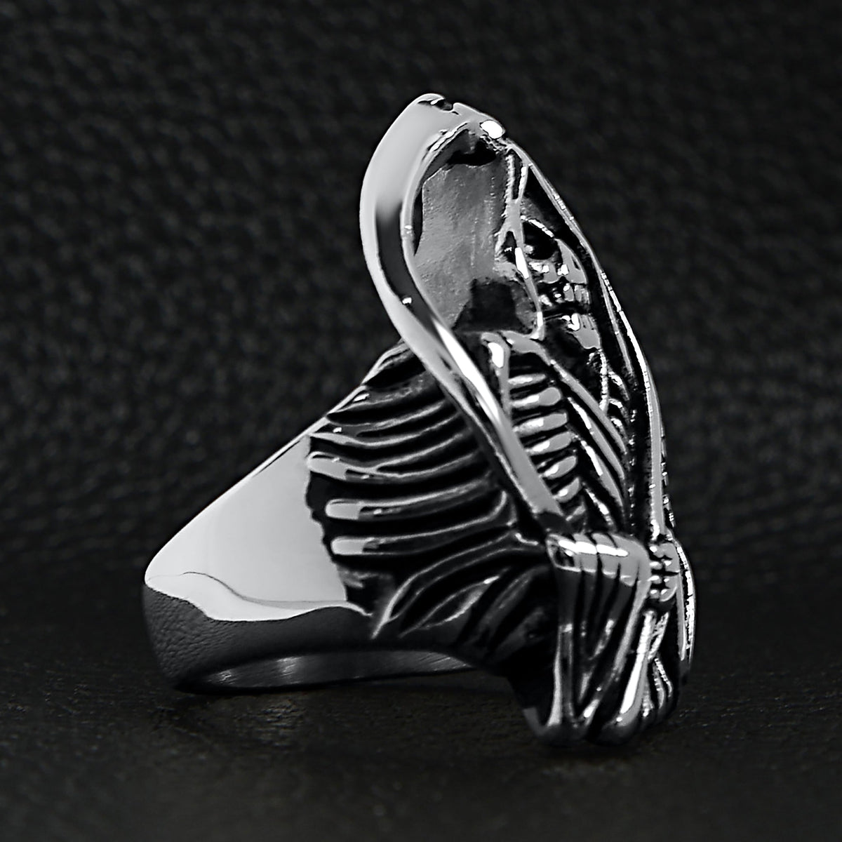Silver grim reaper skull ring, detailed skeleton design, shown flat on black background | Chaps London