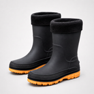 Studio three quarter view of a pair of black rubber rain boots with black fleece cuffs, a textured black welt band and chunky orange soles.