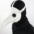 White plague doctor mask with beak worn by person in black hood | Chaps London