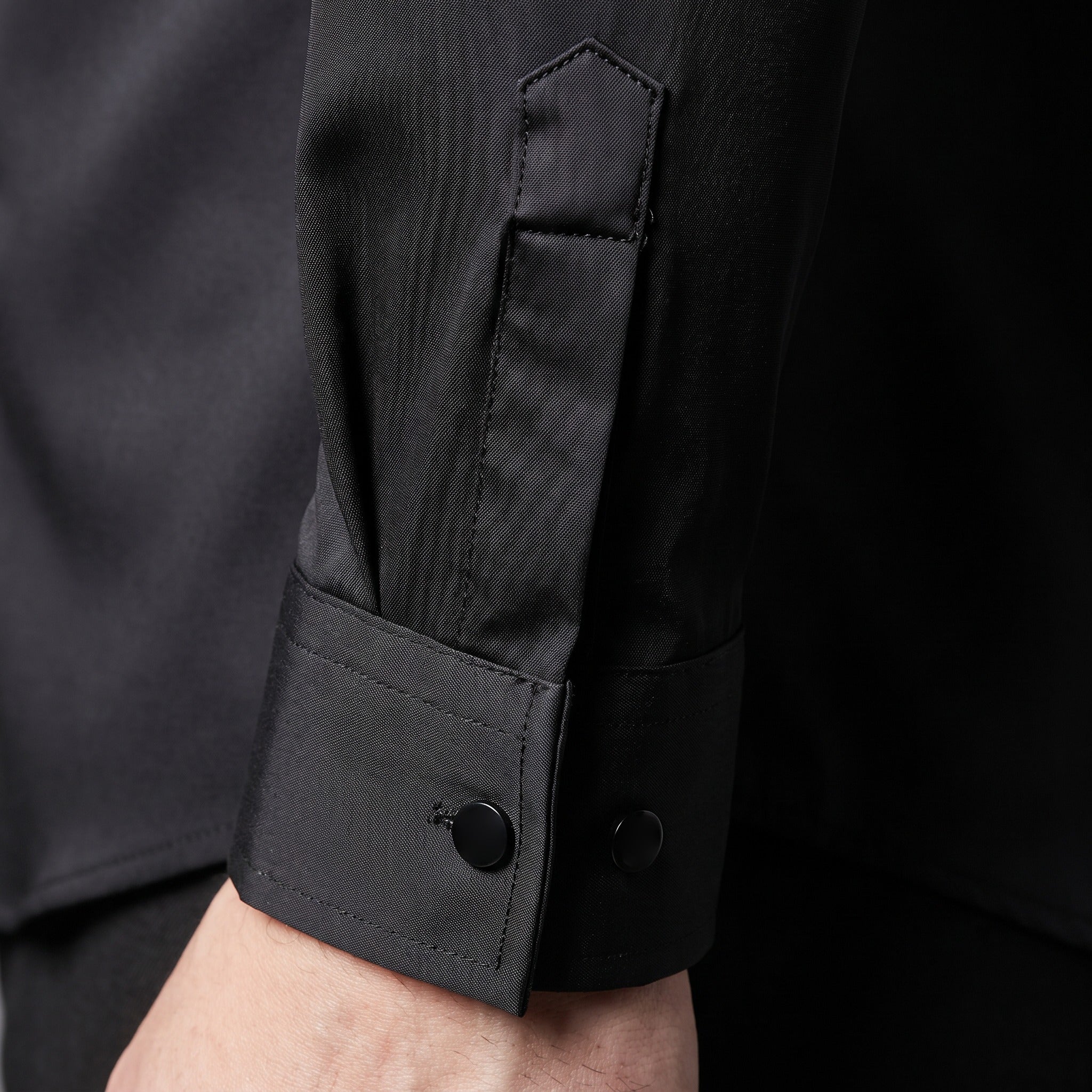 Black long sleeve shirt cuff with button detail, worn by person | Chaps London