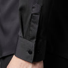 Black long sleeve shirt cuff with button detail, worn by person | Chaps London