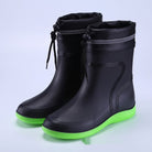 Black ankle rain boots with drawstring cuff and green sole, pair shown | Chaps London