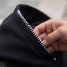 Black hoodie with white striped trim hood, worn, close-up view | Chaps London