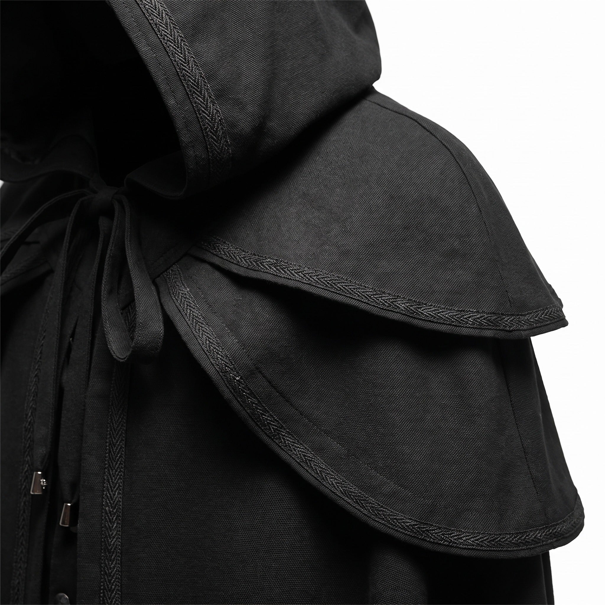 Black hooded cape with layered shoulder cape, braided trim detail, close-up view | Chaps London