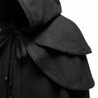 Black hooded cape with layered shoulder cape, braided trim detail, close-up view | Chaps London