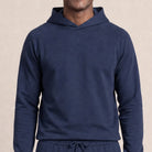 Man wearing navy raglan hoodie, worn, front view, close-up torso | Chaps London