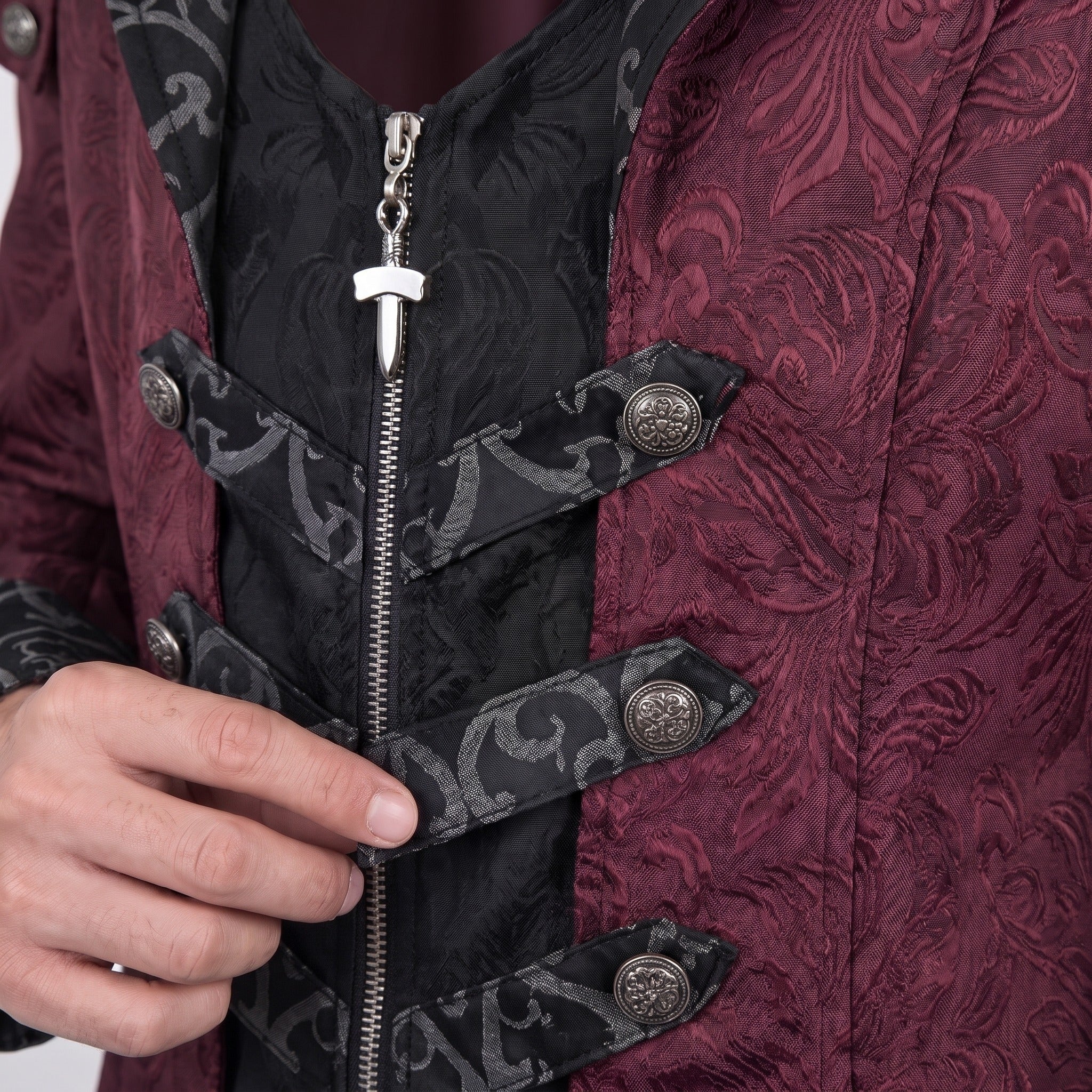Worn close-up of burgundy jacquard coat with black trim and zipper detail | Chaps London