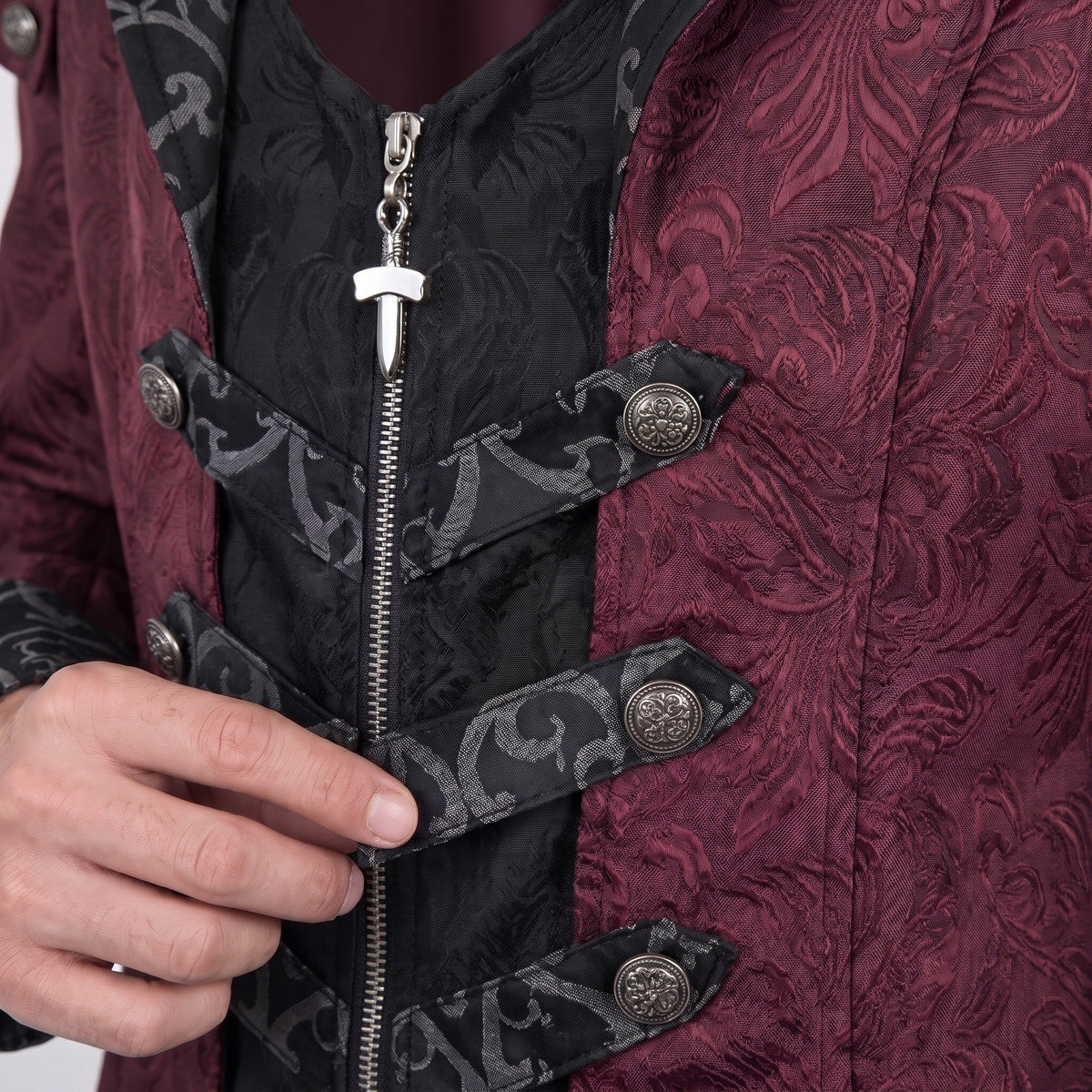 Worn close-up of burgundy jacquard coat with black trim and zipper detail | Chaps London