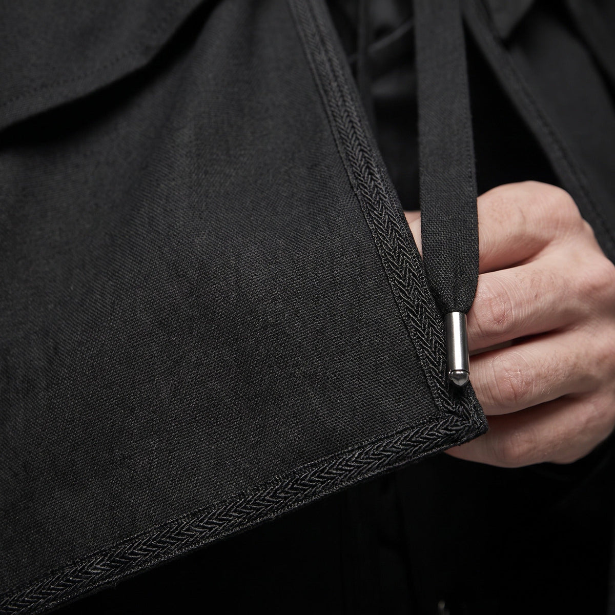 Black hooded cape detail, herringbone trim, hand adjusting metal cord toggle | Chaps London