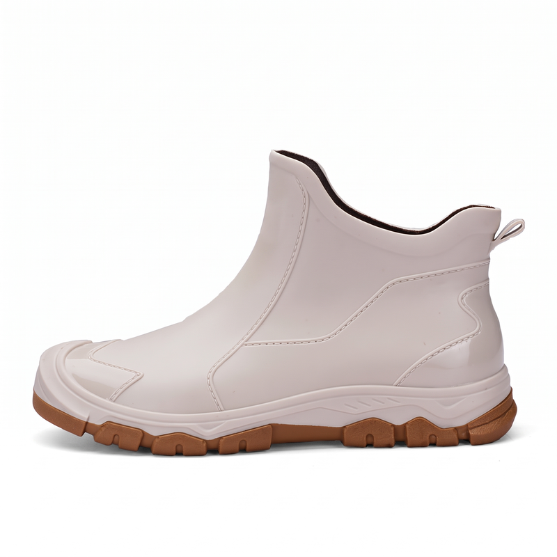 A beige ankle boot with a brown lug sole shown from the side on a white background.