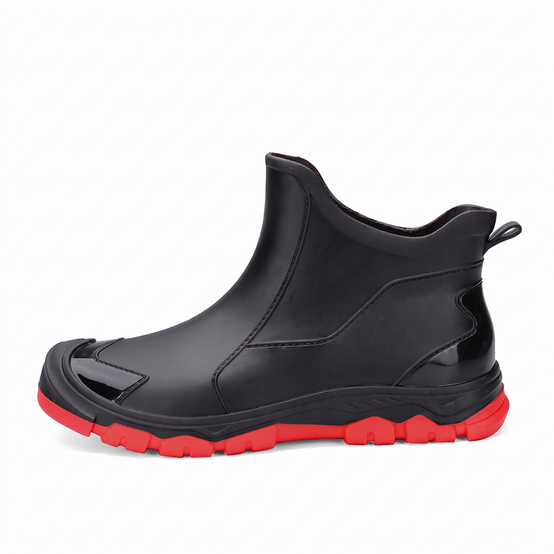 A black rubber ankle boot with a red sole shown from the side on a white background.
