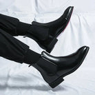 Black faux leather Chelsea boots with red sole, worn on feet | Chaps London
