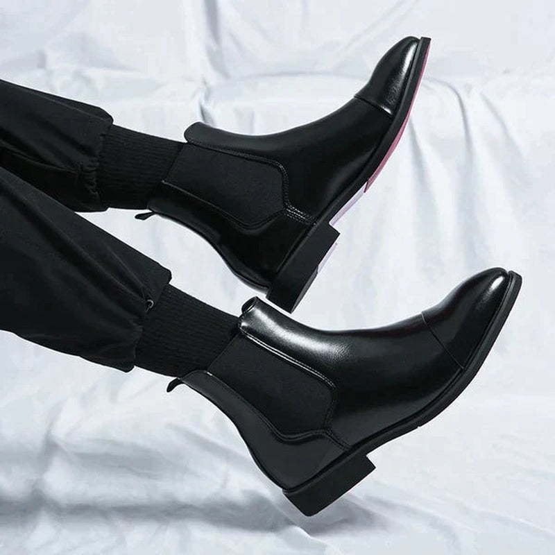 Black faux leather Chelsea boots with red sole, worn on feet | Chaps London