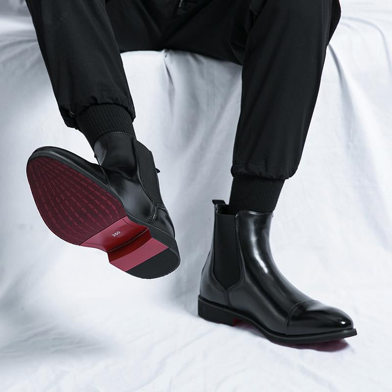 Black Chelsea boot worn on foot, showing red and black textured sole | Chaps London