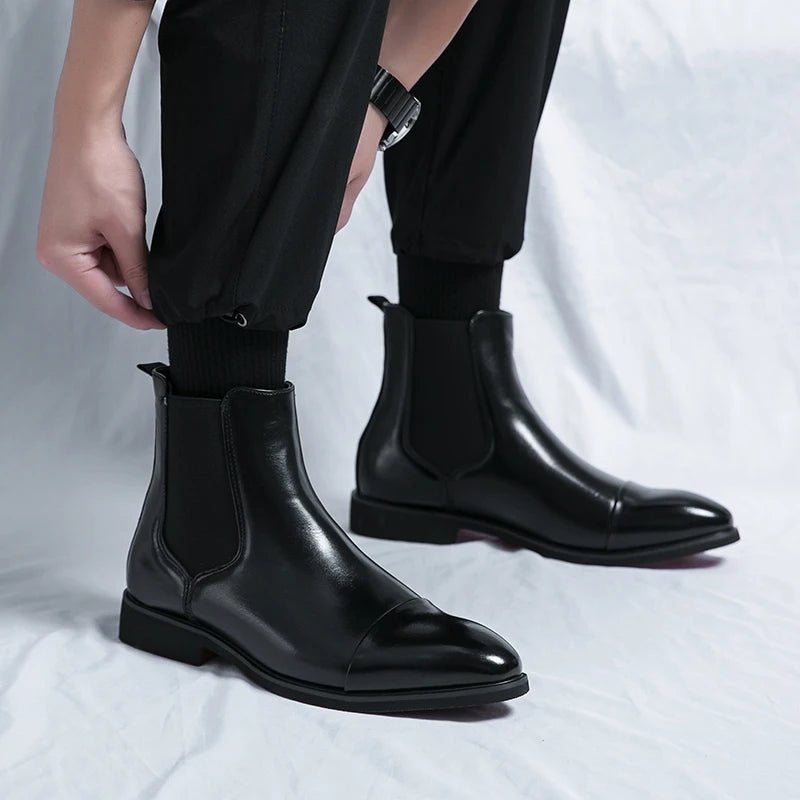 Black faux leather Chelsea boots worn by person, slip-on style, cuffed pants | Chaps London