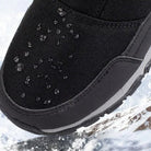Black fabric snow boot close-up with water droplets on toe area | Chaps London