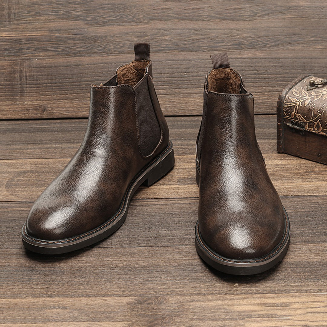 Brown leather Chelsea ankle boots with elastic side panels, displayed flat on wood | Chaps London