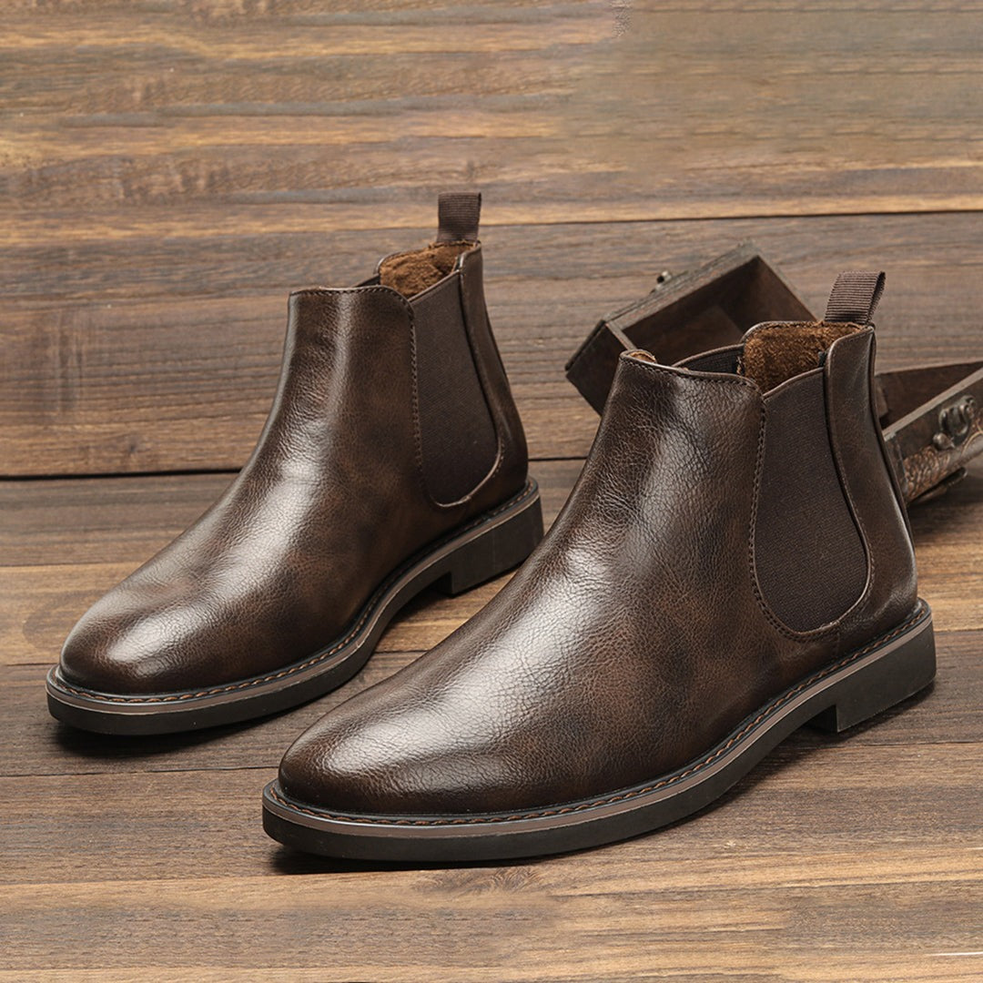 Brown leather Chelsea boots with elastic side panels, displayed flat on wood | Chaps London