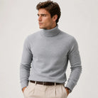 Man wearing gray ribbed turtleneck sweater with beige trousers, worn by model | Chaps London