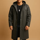 Man wearing dark olive hooded long raincoat with snap front, worn on model | Chaps London